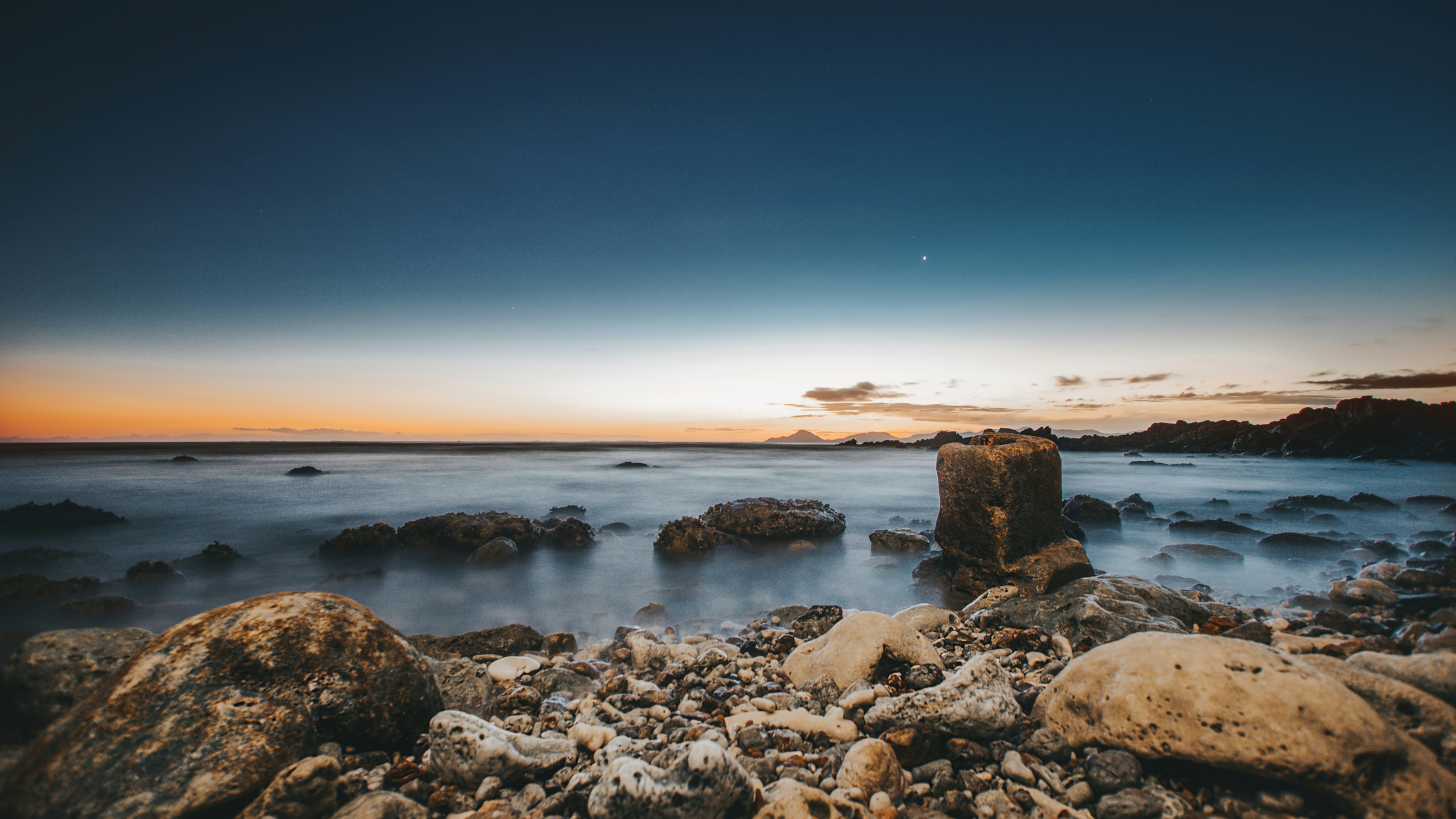 assorted-color rocks beside sea